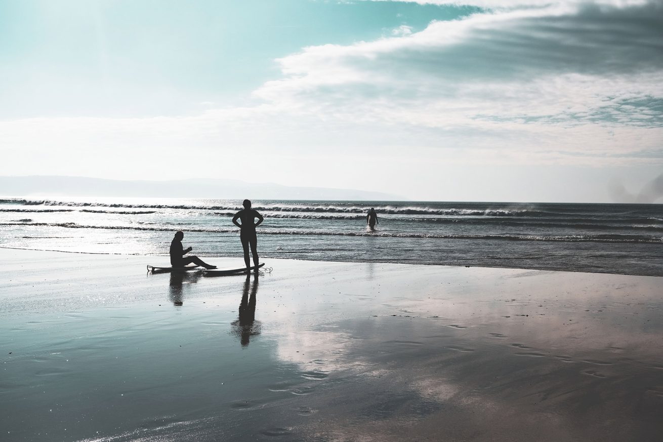 Reflections of Surfers on Godrevy Beach in Cornwall
