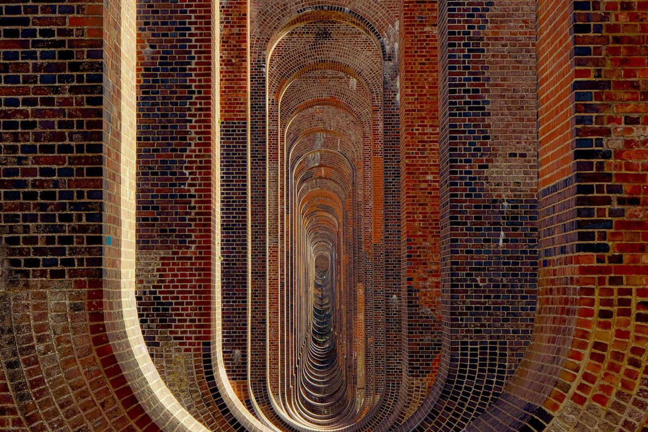 Red brick Architectural arches of the Ouse Valley Viaduct in Sussex, photographed by Rachel Groom