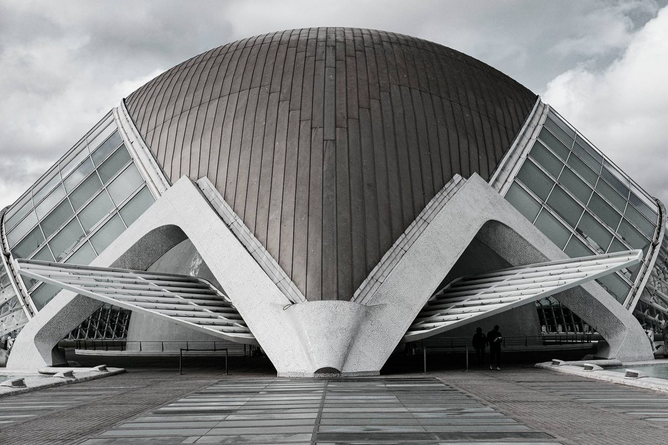 Futuristic dome-shaped building at Valencia Science Park with geometric architectural details and cloudy sky